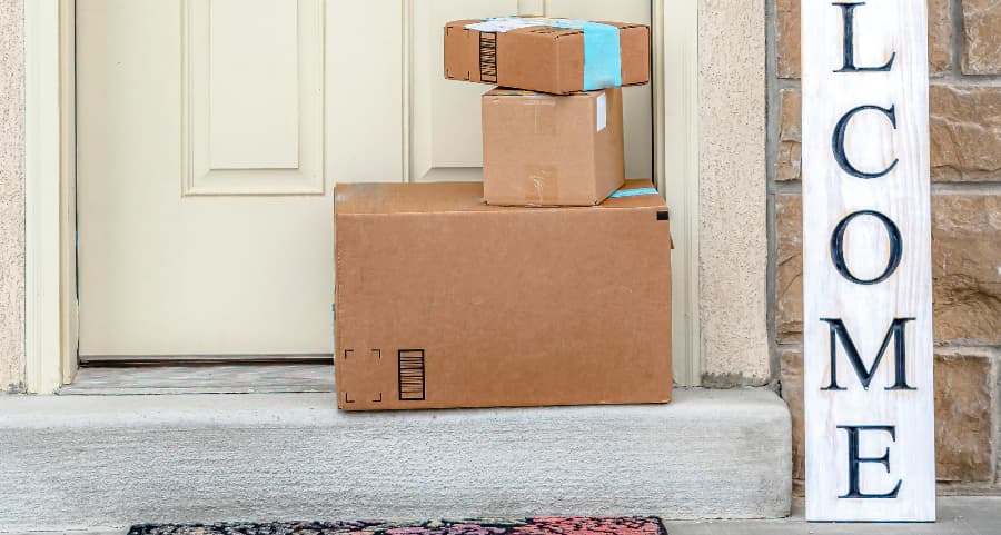 Boxes by the door of a residence with a welcome sign in Greenville